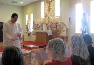 Fr. Ambrose Little, OP, enrolling the young women into the Confraternity